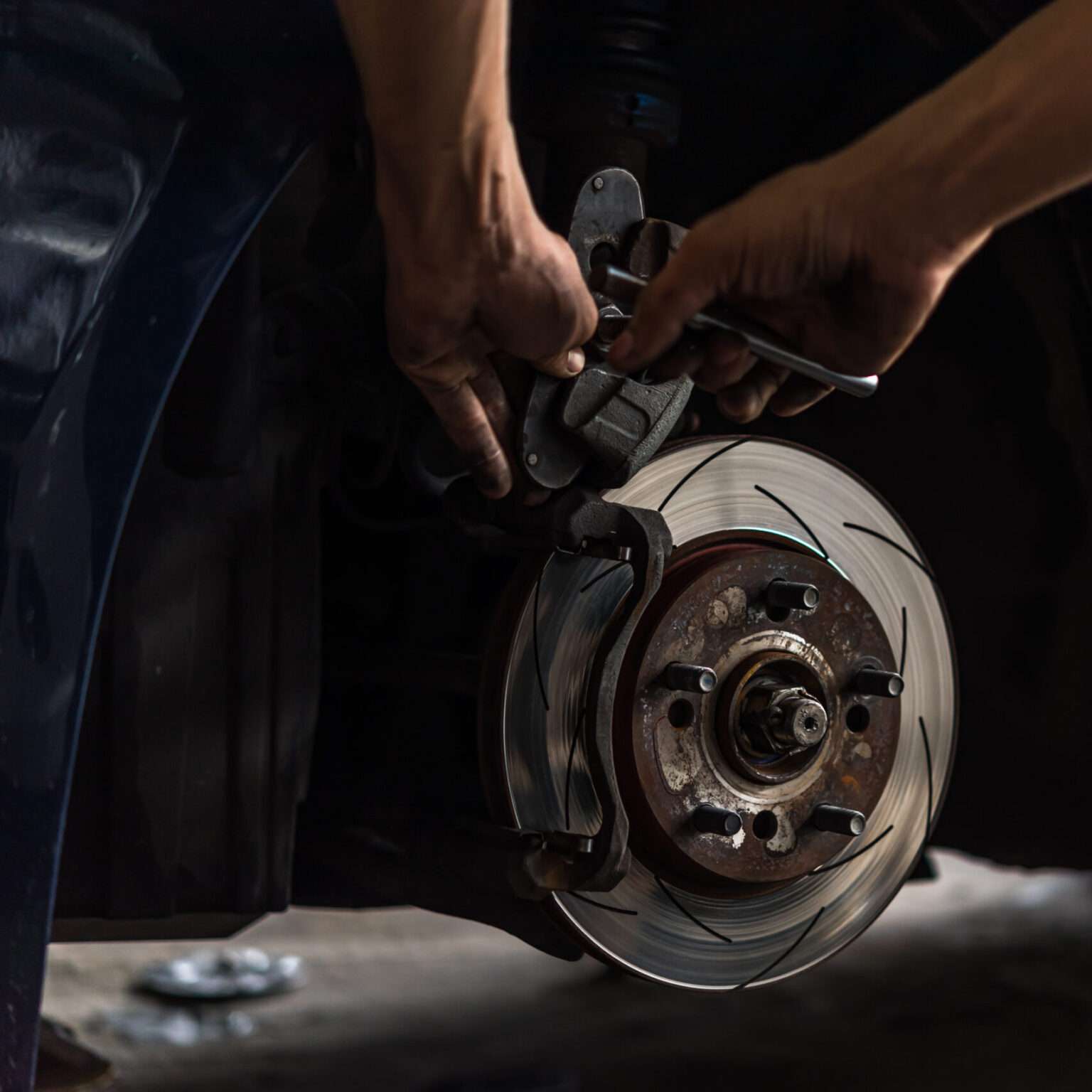 automan mechanic changing car brakes.